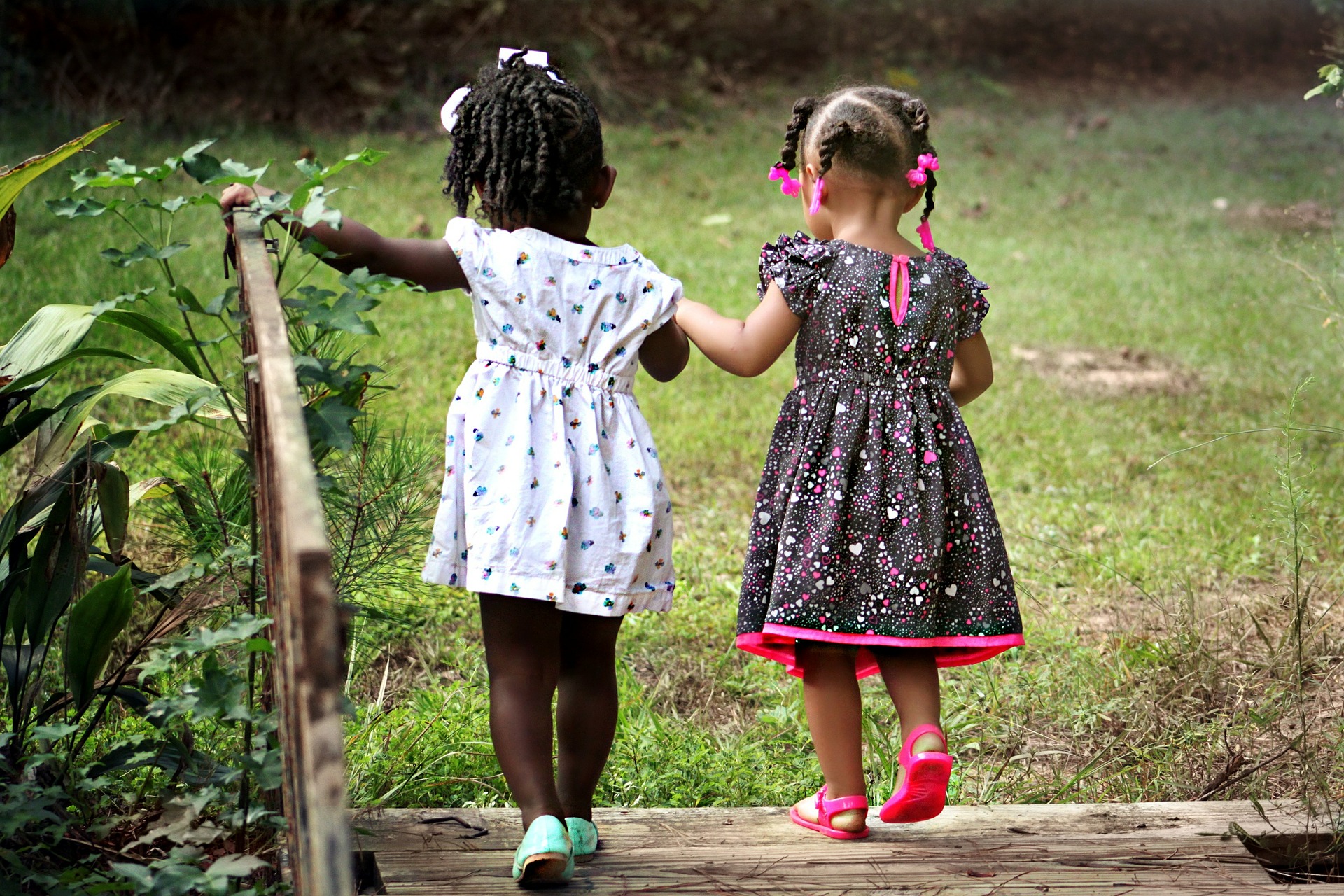 Two girls playing on a bridge at holiday club